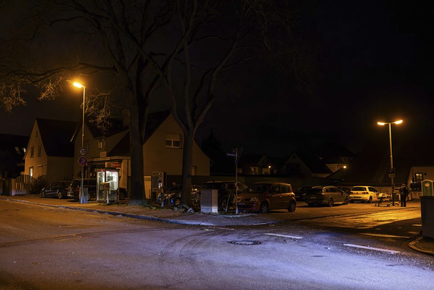 The light of a car illuminates the spot where a carnival float caught fire in the afternoon, in Kehl, Germany, Sunday Feb. 4, 2024. (Philipp von Ditfurth/dpa via AP)