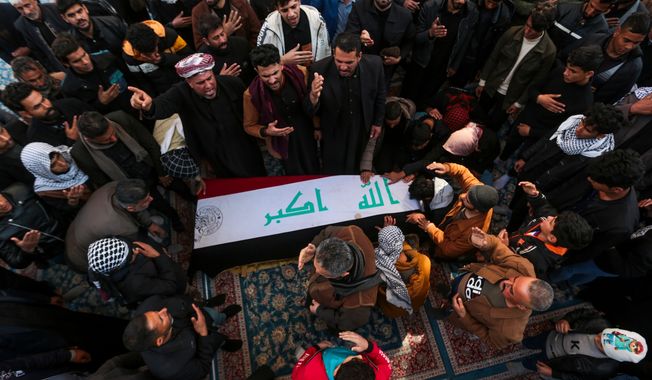 Iraqis attend the funeral of Popular Mobilization Forces fighters killed in the U.S. airstrikes at the Imam Ali shrine in Najaf, Iraq, Sunday, Feb. 4, 2024. (AP Photo/Anmar Khalil)