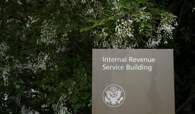 A sign for the Internal Revenue Service building in Washington, on May 4, 2021. The IRS says it expects to collect hundreds of billions of dollars more in overdue and unpaid taxes than previously anticipated using funding provided to the agency by the Democrats&#x27; Inflation Reduction Act.(AP Photo/Patrick Semansky, File)