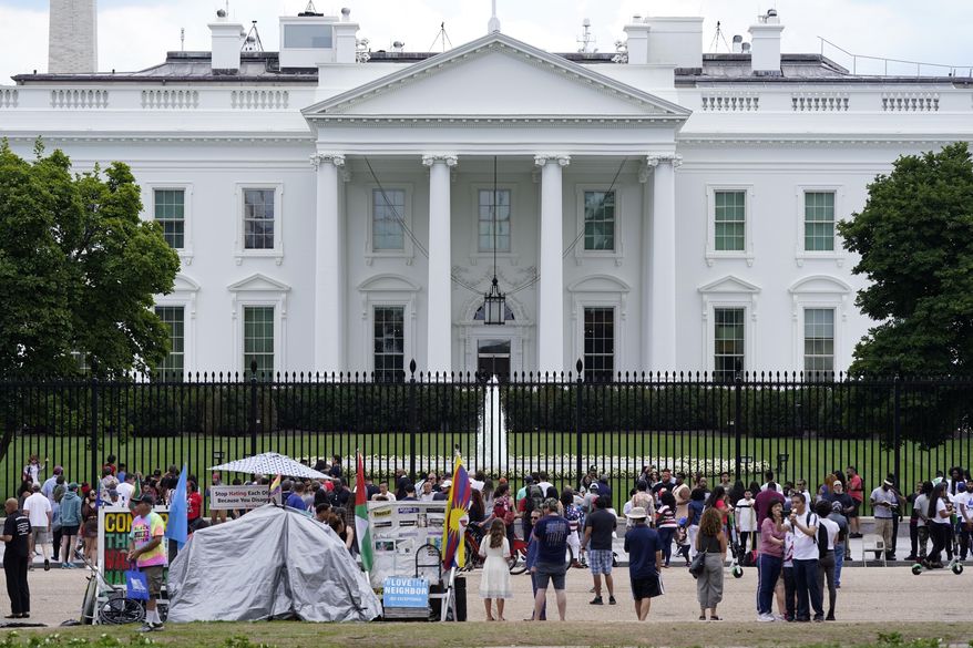 People gather on a section of Pennsylvania Avenue in front of the White House, July 4, 2021, in Washington. The Biden administration on Wednesday, Feb. 7, 2024, will name Elizabeth Kelly, a top White House aide, as the director of the newly established safety institute for artificial intelligence. (AP Photo/Patrick Semansky, File)