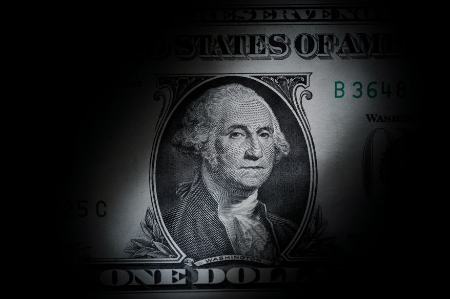 The likeness of George Washington is seen on a U.S. one dollar bill, March 13, 2023, in Marple Township, Pa. The Congressional Budget Office says it expects the federal budget deficit to drop by $188 billion this fiscal year to $1.5 trillion. But it's likely to be a short-lived dip as the annual shortfall will likely rise over the next nine years. (AP Photo/Matt Slocum, File)