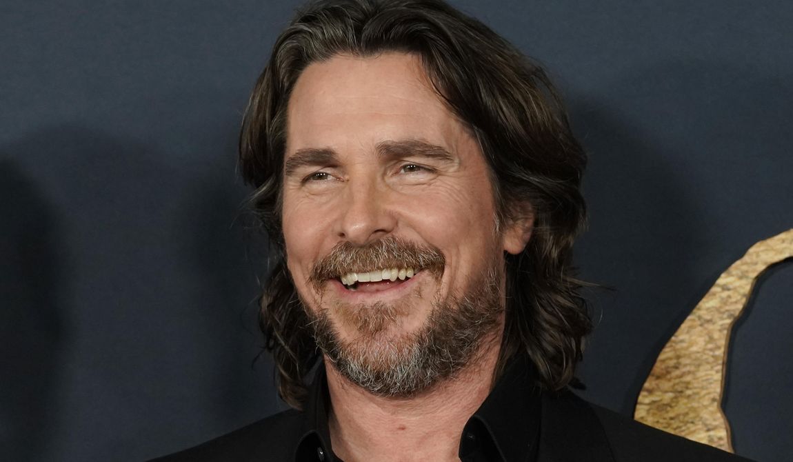 Christian Bale and cast members in &quot;The Pale Blue Eye,&quot; share a laugh at the premiere of the film, Wednesday, Dec. 14, 2022, at the Directors Guild of America in Los Angeles. Bale has broken ground Wednesday, Feb. 7, 2024, on a project he’s been pursuing for 16 years -- the building of a dozen homes and a community center intended to keep siblings in foster care together. (AP Photo/Chris Pizzello, File)