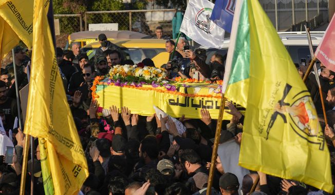 Fighters from the Popular Mobilization Forces, carry the coffin of a commander from the Kataib Hezbollah paramilitary group, Wissam Muhammad Sabir Al-Saadi, known as Abu Baqir Al-Saadi, who was killed in a U.S. airstrike, in Baghdad, Iraq, Thursday, Feb. 8, 2024. The U.S. military says a U.S. drone strike blew up a car in the Iraqi capital Wednesday night, killing the high-ranking commander. (AP Photo/Hadi Mizban) ** FILE **