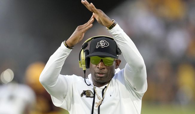 Colorado head coach Deion Sanders calls for a timeout during the second half of an NCAA college football game against Arizona State, Saturday, Oct. 7, 2023, in Tempe, Ariz. Deion Sanders has put the finishing touches on his Colorado coaching staff, bringing in Robert Livingston as defensive coordinator and sticking with Pat Shurmur to oversee the offense. (AP Photo/Ross D. Franklin) **FILE**