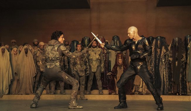 This image released by Warner Bros. Pictures shows Timothee Chalamet, foreground left, and Austin Butler in a scene from &quot;Dune: Part Two.&quot; (Warner Bros. Pictures via AP)