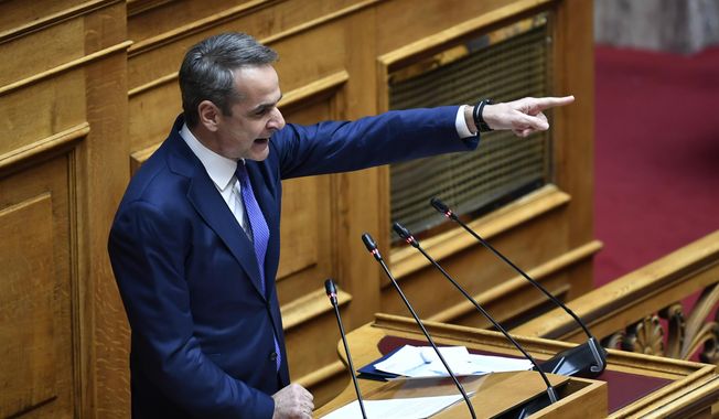 Greece&#x27;s Prime Minister Kyriakos Mitsotakis speaks during a debate in Parliament on same-sex marriage in Athens, Greece, Thursday, Feb. 15, 2024. Mitsotakis&#x27; center-right government is poised to make Greece the first Orthodox Christian-majority country to approve marriage equality legislation. (AP Photo/Michael Varaklas)