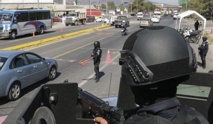 State police maintain a security checkpoint at the entrance of Chilpancingo, Mexico, Thursday, Feb. 15, 2024. Four Roman Catholic bishops met with Mexican drug cartel bosses in a bid to negotiate a possible peace accord, according to the Bishop of Chilpancingo-Chilapa, José de Jesús González Hernández. (AP Photo/Alejandrino Gonzalez)