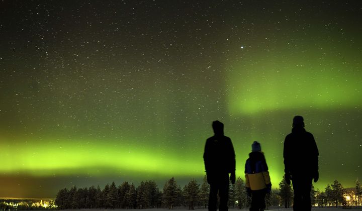 The northern lights, aurora borealis, illuminate the sky above the village of Akaslompolo in Kolari, beyond the Arctic Circle, Finnish Lapland, Sunday, Feb. 11, 2024. (Laurent Gillieron/Keystone via AP)