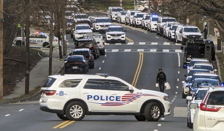 Washington, D.C., Metropolitan Police are shown near a scene where three police officers were shot and a fourth suffered minor injuries while responding to a shooting, Wednesday morning, Feb. 14, 2024, in Washington. (AP Photos/Nathan Ellgren) ** FILE **