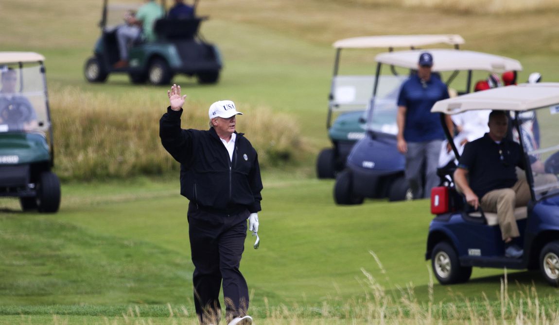 Then-President Donald Trump waves to protesters while playing golf at Turnberry golf club, in Turnberry, Scotland, July 14, 2018. President Biden&#x27;s reelection campaign blasted former President Donald Trump for golfing on his day off from court after he complained that his criminal hush-money trial was keeping him off the campaign trail. (AP Photo/Peter Morrison, File)