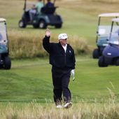 Then-President Donald Trump waves to protesters while playing golf at Turnberry golf club, in Turnberry, Scotland, July 14, 2018. President Biden&#x27;s reelection campaign blasted former President Donald Trump for golfing on his day off from court after he complained that his criminal hush-money trial was keeping him off the campaign trail. (AP Photo/Peter Morrison, File)