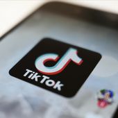 The TikTok logo is displayed on a smartphone screen, Sept. 28, 2020, in Tokyo, Japan. The European Union is looking into whether TikTok has broken the bloc’s strict new digital rules for cleaning up social media and keeping internet users safe. (AP Photo/Kiichiro Sato, File)