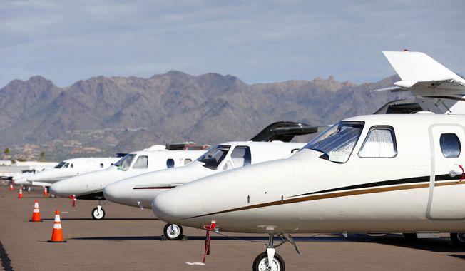 Private jets sit parked at Scottsdale Airport Jan. 27, 2015, in Scottsdale, Ariz. IRS leadership said Wednesday, Feb. 21, 2024, that the agency will start up dozens of audits on businesses&#x27; private jets and how they are used personally by executives and written off as a tax deduction — as part of the agency&#x27;s ongoing mission of going after high-wealth tax cheats who game the tax system at the expense of American taxpayers. (AP Photo/Ross D. Franklin, File)