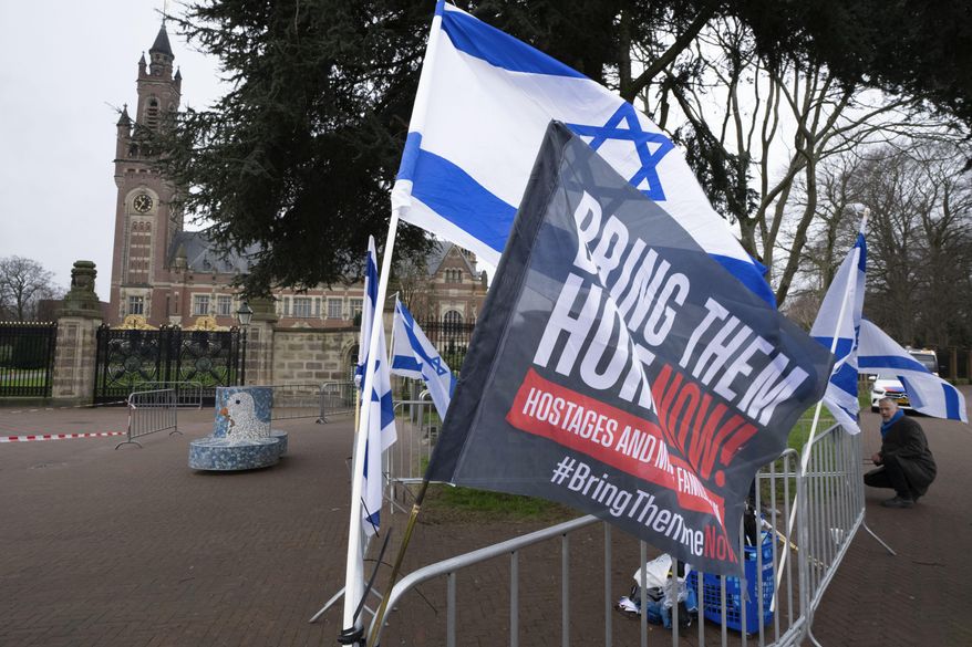 Israeli flags outside the United Nations' highest court, rear left, during historic hearings in The Hague, Netherlands, Wednesday, Feb. 21, 2024, into the legality of Israel's 57-year occupation of the West Bank and east Jerusalem, plunging the 15 international judges back into the heart of the decades-long Israeli-Palestinian conflict. (AP Photo/Peter Dejong) ** FILE **