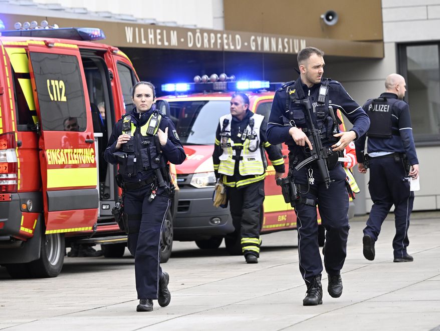 Police and ambulances at the scene of an attack, at the Wilhelm Dörpfeld school, in Wuppertal, Germany, Thursday, Feb. 22, 2024. Police say five people have been injured in an incident at a school in the western German city of Wuppertal and a suspect has been arrested. The incident took place on Thursday at a high school. Police said there was no shooting in the incident but gave no further information. (Roberto Pfeil/dpa via AP)
