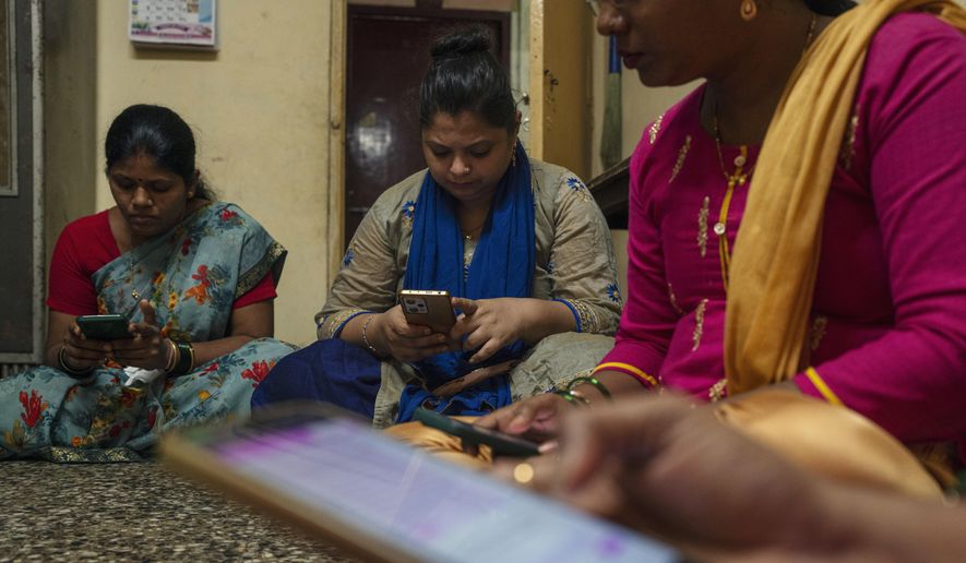 Women learn to use a chatbot powered by artificial intelligence developed by Myna Mahila Foundation at the local women's organization’s office in Mumbai, India, Feb. 1, 2024. (AP Photo/Rafiq Maqbool) ** FILE **