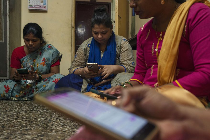 Women learn to use a chatbot powered by artificial intelligence developed by Myna Mahila Foundation at the local women's organization’s office in Mumbai, India, Feb. 1, 2024. (AP Photo/Rafiq Maqbool) ** FILE **
