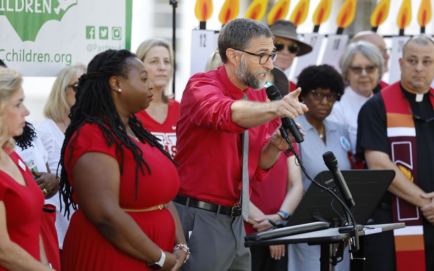 FILE - N.C. Association of Educators Vice President Bryan Proffitt speaks during a news conference held by Every Child NC in Raleigh, N.C., Aug. 31, 2022. The press conference was held to urge the N.C. Supreme Court to order the state to fund the Leandro plan. The North Carolina Supreme Court scheduled oral arguments Thursday, Feb. 22, 2024, in an education funding case barely a year after a majority of justices — all Democrats — ruled on whether a trial judge could move taxpayer money to address schooling inequities statewide without the express approval of legislators. The court now has a Republican majority that decided to take up again a portion of the case known as “Leandro.” (Ethan Hyman/The News & Observer via AP, File)