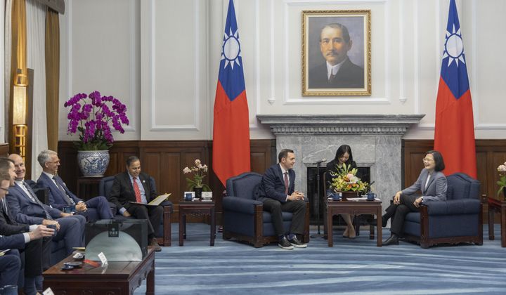 In this photo released by the Taiwan Presidential Office, Taiwan&#x27;s President Tsai Ing-wen, right, talks to Rep. Mike Gallagher, the Republican chair of the House Select Committee on the Chinese Communist Party, center, as she meets with members of United States Congressmen, in Taipei, Taiwan, Thursday, Feb. 22, 2024. (Taiwan Presidential Office via AP)