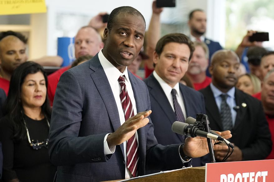 Florida Surgeon General Dr. Joseph Ladapo gestures as speaks to supporters and members of the media before a bill signing by Gov. Ron DeSantis Thursday, Nov. 18, 2021, in Brandon, Fla. Florida's controversial surgeon general is drawing criticism for his handling of an elementary school's measles outbreak, telling parents of unvaccinated children it is their choice whether their student attends class — a direct contravention of federal guidelines. (AP Photo/Chris O'Meara, File)