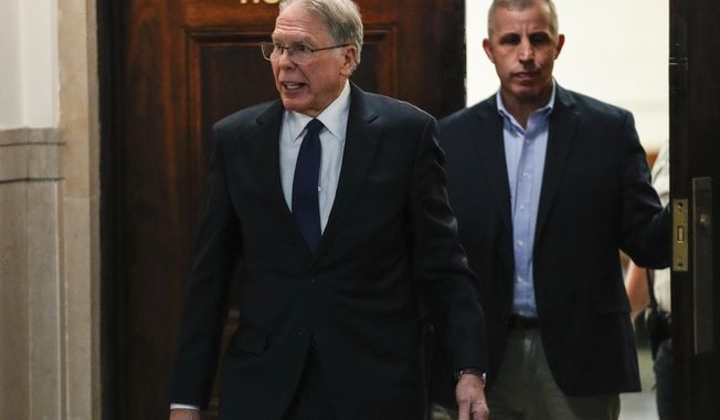 Wayne LaPierre, left, CEO of the National Rifle Association, leaves the courtroom as a jury continues deliberations during a trial at New York State Supreme Court, Wednesday, Feb. 21, 2024, in New York. (AP Photo/Frank Franklin II)