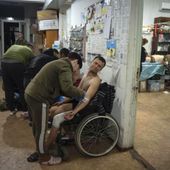 Military medics give first aid to wounded Ukrainian soldiers near Bakhmut, Ukraine, Thursday, Jan. 25, 2024. (AP Photo/Efrem Lukatsky)