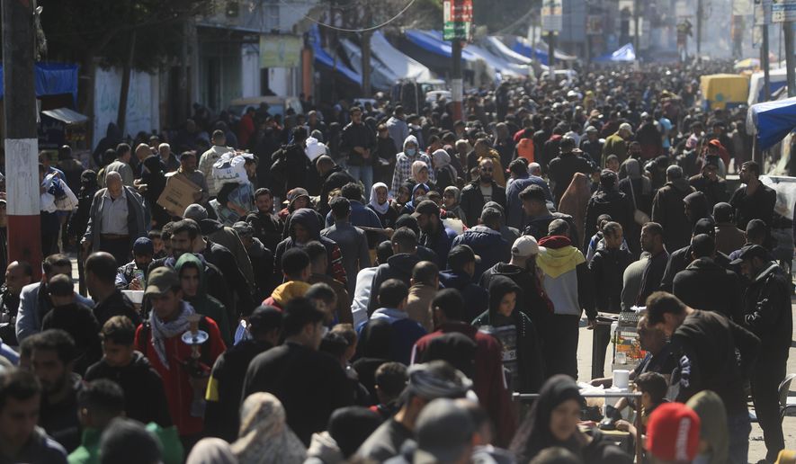 Palestinians crowd a market in Rafah, Gaza Strip, Thursday, Feb. 22, 2024. An estimated 1.5 million Palestinians displaced by the war took refuge in Rafahor, which is likely Israel's next focus in its war against Hamas. (AP Photo/Mohammed Dahman)