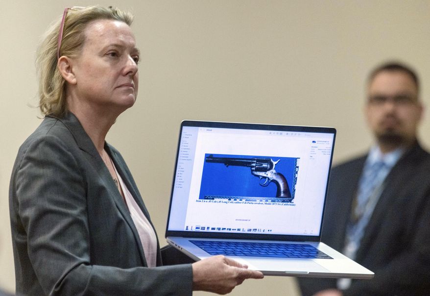 Special prosecutor Kari Morrissey shows defense attorney Jason Bowles a picture of a firearmReed during Hannah Gutierrez-Reed trial at District Court, Monday, Feb. 26, 2024, in Santa Fe, N.M. Gutierrez-Reed is charged with involuntary manslaughter and tampering with evidence in the October 2021 death of cinematographer Halyna Hutchins during the filming of the Western “Rust”. (Luis Sánchez Saturno/Santa Fe New Mexican via AP, Pool)