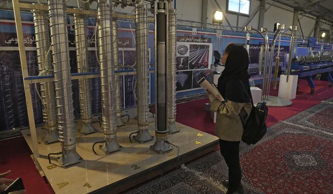 A student looks at Iran&#x27;s domestically built centrifuges in an exhibition of the country&#x27;s nuclear achievements, in Tehran, Iran, Wednesday, Feb. 8, 2023. Iran has further increased its total stockpile of uranium, according to a report by the United Nations’ nuclear watchdog seen by The Associated Press on Monday, and continues to bar several of the most experienced inspectors from monitoring its nuclear program. The IAEA report estimated that as of Feb. 10, Iran’s total enriched uranium stockpile was at 5,525.5 kilograms, an increase of 1038.7 kilograms since the last quarterly report in November 2023. (AP Photo/Vahid Salemi) **FILE**