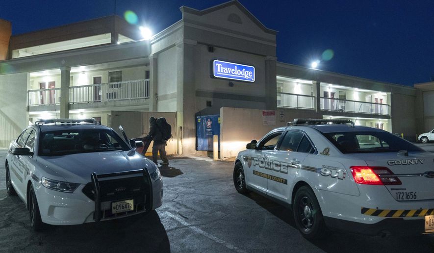 Montgomery County, Md., police cars sit in the parking lot at the Travelodge hotel in Silver Spring, Md., Monday, Feb. 26, 2024. Aaron Bushnell of San Antonio, an active-duty member of the U.S. Air Force has died after he set himself ablaze outside the Israeli Embassy in Washington. Investigators believe Bushnell had been staying at a Travelodge in Silver Spring, Maryland, which was searched Monday by federal agents, a law enforcement official said. (AP Photo/Jose Luis Magana)