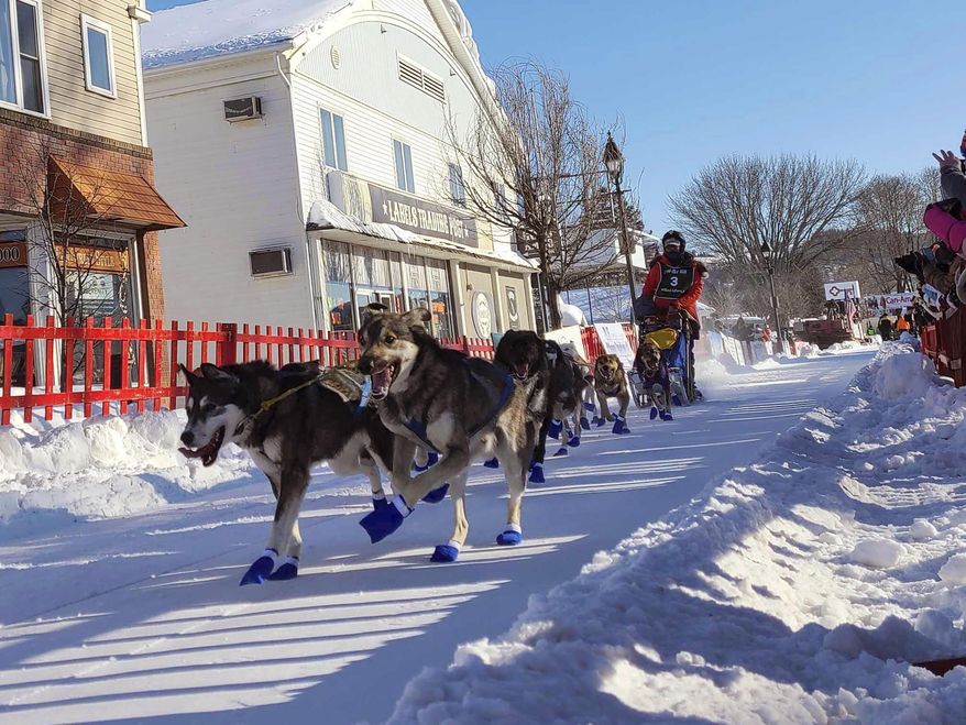 FILE - Patty Richards from Vermont takes off with her team of sled dogs at the start of the Can-Am 100 Saturday, March 5, 2022 in Fort Kent, Maine. The organizers of the longest sled dog race in the eastern United States said Monday, Feb. 26, 2024, they are canceling the event due to a lack of snow on the ground. The Can-Am Crown International Sled Dog Races have taken place in northern Maine for more than three decades, and they include a 250-mile event that is the marquee sled dog race in New England. But this year, snow has been well below average in Maine, and it's not safe to run the races, organizers said.(Emily Jerkins/The Bangor Daily News via AP, File)/The Bangor Daily News via AP, File)