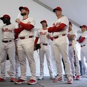 Philadelphia Phillies players wait to have their photo taken during a baseball spring training photo day Thursday, Feb. 22, 2024, in Clearwater, Fla. Baseball players’ association head Tony Clark is hopeful 2024 uniforms will soon be altered following complaints by his members. The uniforms designed by Nike and manufactured by Fanatics have been criticized by players for pants that are somewhat see through and for lettering, sleeve emblems and numbering that are less bulky and apparently smaller.(AP Photo/Charlie Neibergall, File)