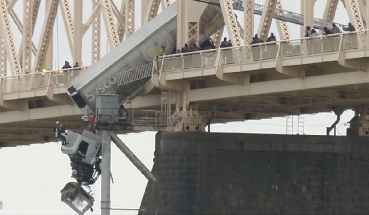 NextImg:WATCH: Truck driver rescued from cab dangling off a Louisville bridge