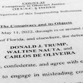 The updated indictment against former President Donald Trump, Walt Nauta and Carlos De Oliveira is photographed July 27, 2023. The federal judge in Florida presiding over the classified documents prosecution of former President Donald Trump has canceled the May 20 trial date, postponing it indefinitely. (AP Photo/Jon Elswick, File)