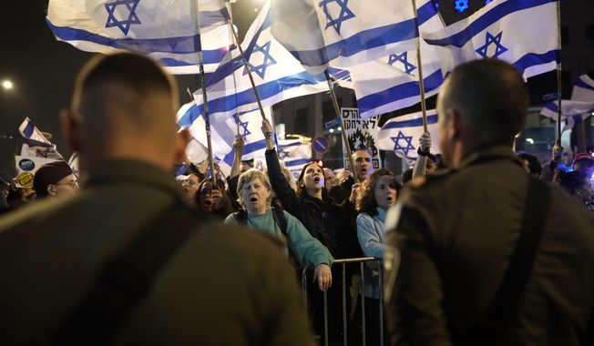 People protest against Israeli Prime Minister Benjamin Netanyahu&#x27;s government in Tel Aviv, Israel, Saturday, March 2, 2024. (AP Photo/Leo Correa)