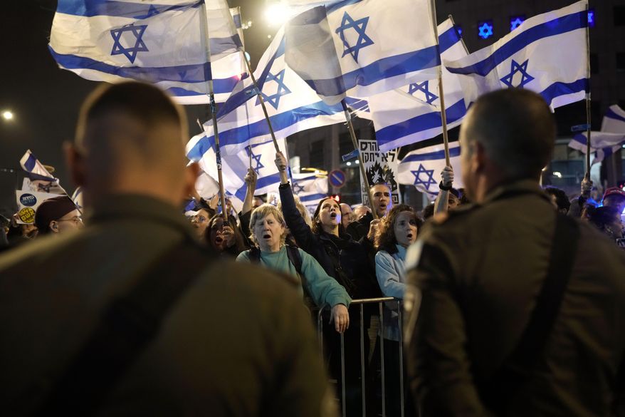 People protest against Israeli Prime Minister Benjamin Netanyahu's government in Tel Aviv, Israel, Saturday, March 2, 2024. (AP Photo/Leo Correa)
