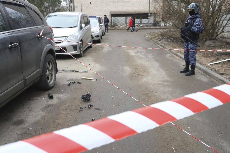 A police officer guards an area with the wreckage of a drone near a damaged apartment's building after a reported drone attack in St. Petersburg, Russia, Saturday, March 2, 2024. Russian authorities said Saturday morning that an "emergency" damaged an apartment building in St. Petersburg. State news agency Tass said that the damage was caused by an "explosion," while local news and social media said that a drone had hit the building. There were no casualties, St. Petersburg Gov. Alexander Beglov wrote on Telegram. (AP Photo)