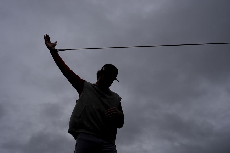A member of the Washington Nationals stretches during a spring training baseball workout Sunday, Feb. 18, 2024, in West Palm Beach, Fla. (AP Photo/Jeff Roberson) **FILE**