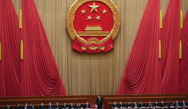 A delegate walks to his seat as they arrive at the closing ceremony for China&#x27;s National People&#x27;s Congress at the Great Hall of the People in Beijing, on Monday, March 13, 2023. (AP Photo/Andy Wong, File)