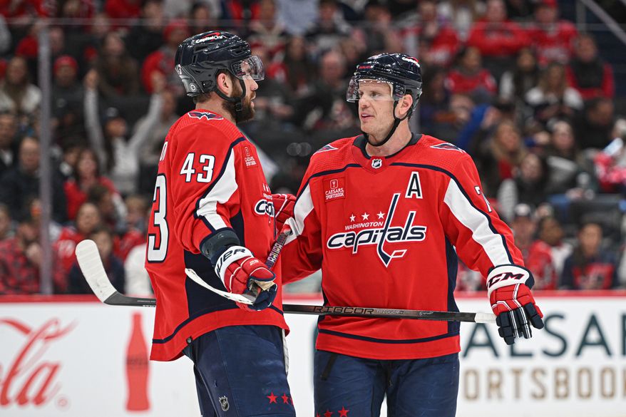 Washington Capitals forward Tom Wilson (43) talking it over with Washington Capitals defenseman John Carlson (74) during a break in the action during the second period of an NHL game against the Arizona Coyotes at Capital One Arena in Washington D.C., March 3, 2024. (Photo by Billy Sabatini)