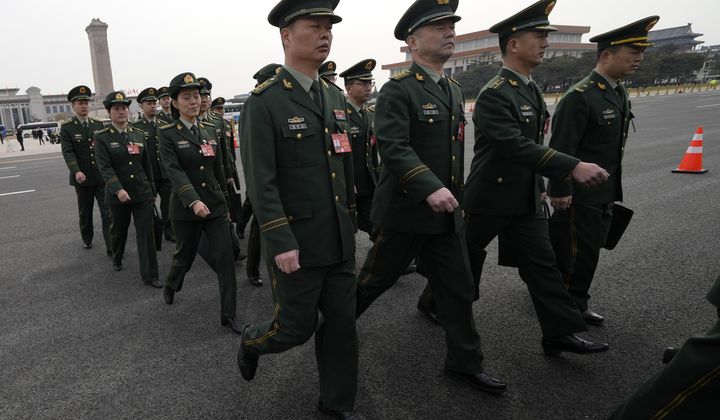 Chinese military officers arrive for a preparatory session of the National People&#x27;s Congress outside the Great Hall of the People in Beijing, Monday, March 4, 2024. (AP Photo/Ng Han Guan)
