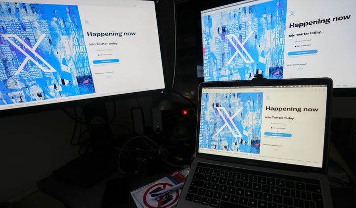 Computer monitors and a laptop display the X, formerly known as Twitter, sign-in page, July 24, 2023, in Belgrade, Serbia. (AP Photo/Darko Vojinovic, File)