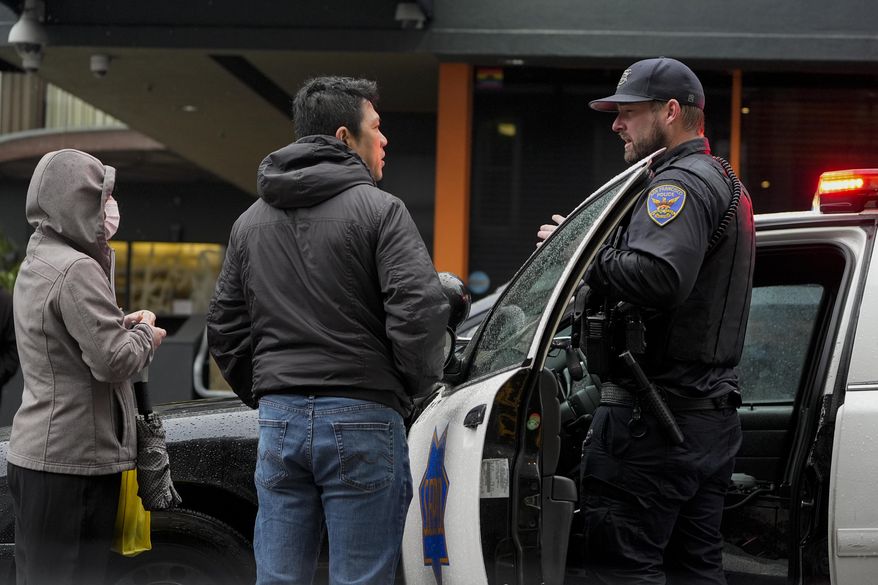 A San Francisco Police Department officer speaks to two people while working in the Tenderloin district Friday, March 1, 2024, in San Francisco. (AP Photo/Godofredo A. Vásquez) **FILE**