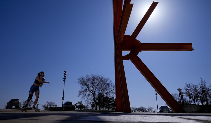 A woman skateboards near a sculpture as she enjoys unseasonably warm weather, Feb. 27, 2024, in Milwaukee. Earth has exceeded global heat records in February, according to the European Union climate agency Copernicus. (AP Photo/Morry Gash) **FILE**