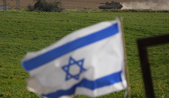 An Israeli tank moves near the Israeli-Gaza border as seen from southern Israel, Wednesday, March 6, 2024. (AP Photo/Ohad Zwigenberg)