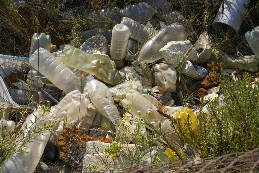 Plastic bottles and other garbage are seen next to a beach at Fiumicino, Italy, near Rome, Saturday, Aug. 15, 2020. We breathe, eat and drink tiny particles of plastic. But are these minuscule specks in the body harmless, dangerous or somewhere in between? A small study published Wednesday, March 6, 2024, in the New England Journal of Medicine raises more questions than it answers about how these bits — microplastics and the smaller nanoplastics — might affect the heart. (AP Photo/Andrew Medichini, File)