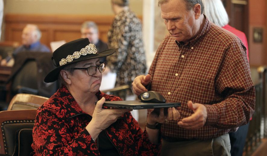 Kansas House Health and Human Services Committee Chair Brenda Landwehr, R-Wichita, left, confers with committee assistant David Long following a House vote on a bill increasing reporting requirements for abortion providers, Thursday, March 7, 2024, at the Statehouse in Topeka, Kan. The House has approved the bill, which requires providers to ask patients why they want abortions and report their answers to the state. (AP Photo/John Hanna)