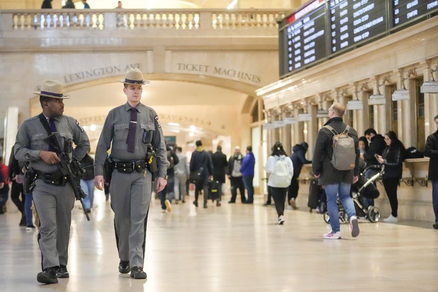 A couple of heavily armed New York State troopers patrol Grand Central terminal, Thursday, March 7, 2024, in New York. New York Gov. Kathy Hochul announced plans Wednesday to send the National Guard to the New York City subway system to help police conduct random searches of riders' bags for weapons following a series of high-profile crimes on city trains. (AP Photo/Mary Altaffer)