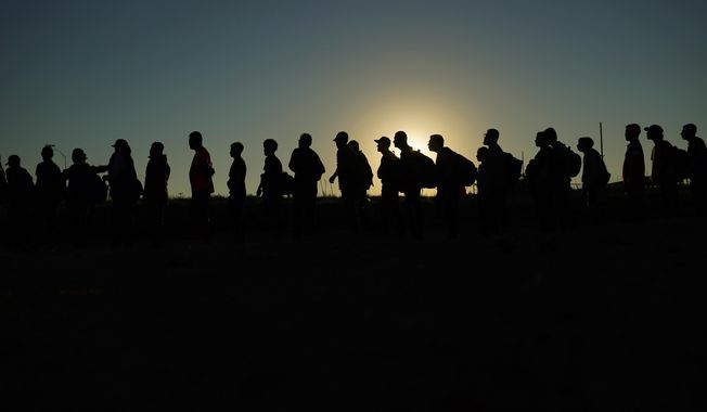 Migrants who crossed the Rio Grande and entered the U.S. from Mexico are lined up for processing by U.S. Customs and Border Protection, Saturday, Sept. 23, 2023, in Eagle Pass, Texas. A federal judge in Texas on Friday, March 8, 2024, upheld a key piece of President Joe Biden’s immigration policy that allows a limited number of migrants from four countries to enter the U.S. on humanitarian grounds, dismissing a challenge from Republican-led states that said the program created an economic burden on them. (AP Photo/Eric Gay, File)