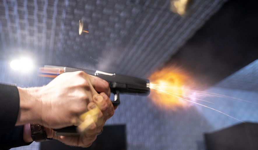 A semi-automatic pistol with a conversion device installed making it fully automatic is fired as four empty shell casings fly out of the weapon, at the Bureau of Alcohol, Tobacco, Firearms, and Explosives (ATF), National Services Center, Thursday, March 2, 2023, in Martinsburg, W.Va. Machine guns have been illegal in the U.S. for decades, but in recent years the country has seen a new surge of weapons capable of automatic fire. Small pieces of plastic or metal used to convert legal guns into homemade machine guns are helping to fuel gun violence. (AP Photo/Alex Brandon)
